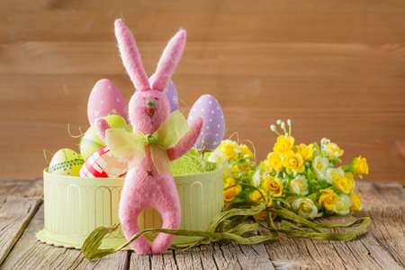 Pink easter rabbit and eggs in sesal nest