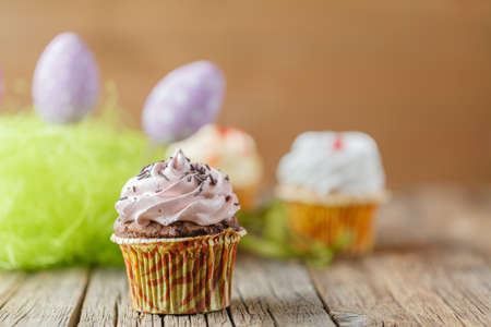 Easter decoration with green grass,eggs and cupcakesの写真素材