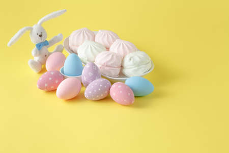 Easter bunny with egg on yellow background