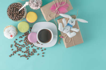 Holiday breakfast decoration with macaroon and cupcakes. Coffee cup