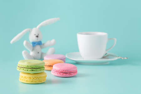 Pastel color macaroon with coffee on aquamarine background with copy spaceの写真素材