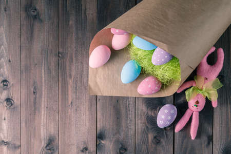 Easter eggs over rustic wooden background. Copy space