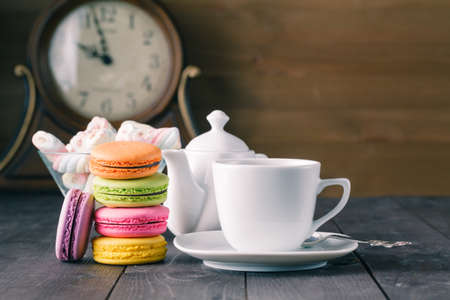 Cup of coffee and french macaron on an old wooden table.の写真素材