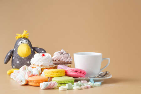 Kid breakfast with sweets, macaroons and twisted marshmalow with toy crowの写真素材
