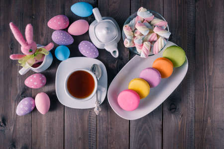 Easter kid breakfst with colored macaroon and pink toy rabbitの写真素材