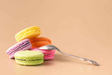 colorful macaroons on beige backgroundの写真素材