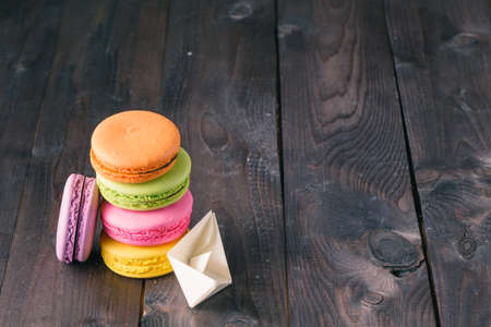 Cup of coffee and french macaron on an old wooden table.の写真素材