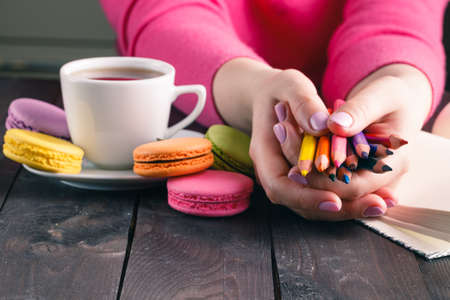 Beautiful woman holding a multicolored pencilsの写真素材