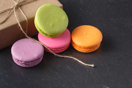 Closeup of assortment macaroons on dark slate tableの写真素材