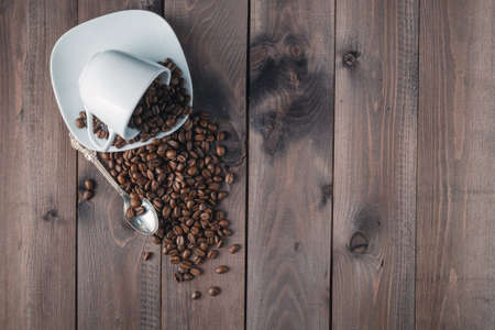 roasted coffee bean in a cup on rustic wood backgroundの写真素材