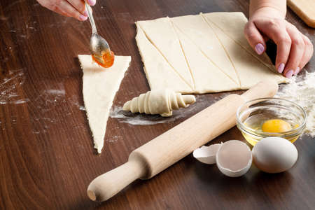 Croissants making on wood table with flourの写真素材