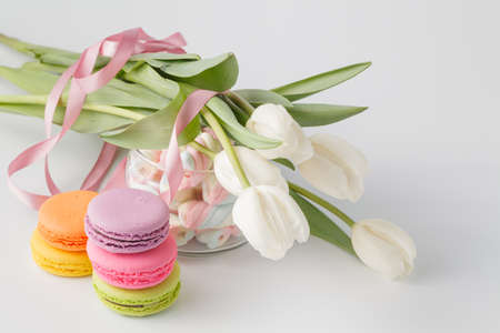Tulips and Jar full of marshmallow and colored macaroonsの写真素材