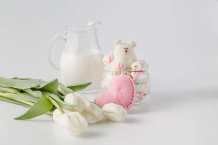 cup of tea with tulips on a white wooden background