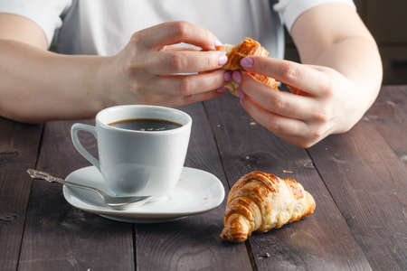 Woman drink coffee with croissant