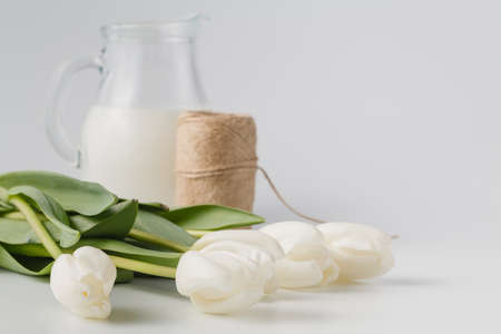 Gift with natural packaging and a white tulipsの写真素材