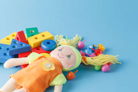 Colorful Toys Collection with doll on blue