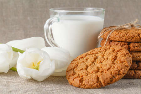 oatmeal cookies and milk with white tulip flowers