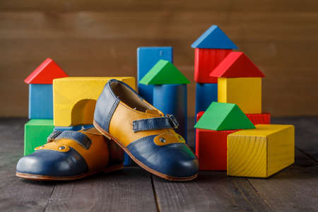 pair of baby shoes on wooden table