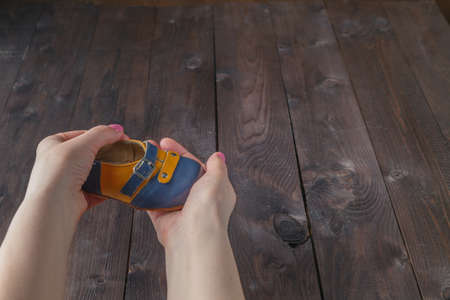 Future parents holding a pair of little shoesの写真素材