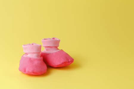 baby booties on a yellow backgroundの写真素材