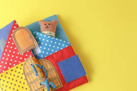 Handmade toy bears on yellow background
