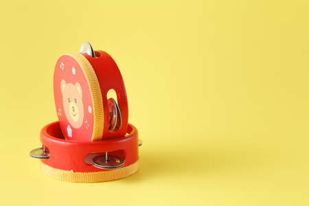 Two red Kids tambourine on yellowの写真素材