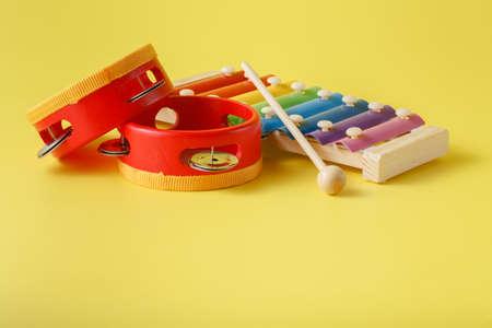 Colorful baby xylophone with stick on yellowの写真素材