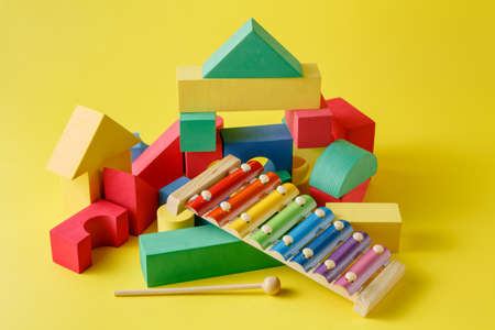 Kid creative play. Building blocks and xillophone on bright backgroundの写真素材