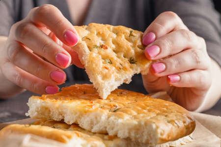 Piece of bread in woman handsの写真素材