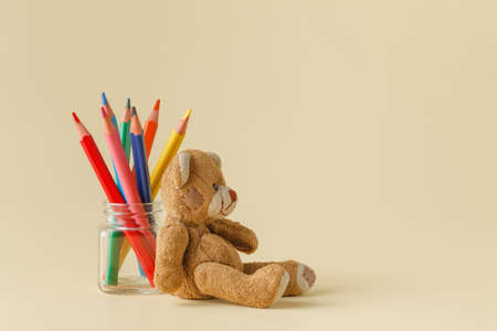 Color pencils in glass jar with toyの写真素材