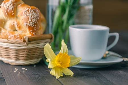 Spring breakfast with pastry and spring flowers in glassの写真素材