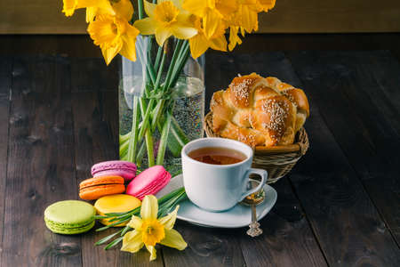 Spring flower on table. Breakfast with tea and french macaroonsの写真素材