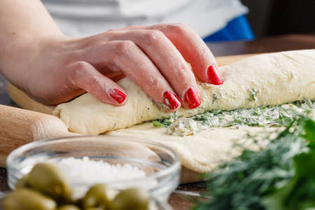 Making ciabatta bread with garlic, mediterranean olivesの写真素材