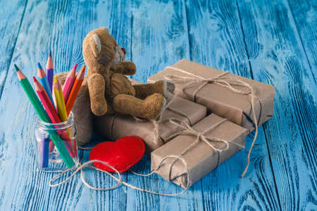 Toy bear and some paper parcels wrapped on wooden table. Vintage Style.の写真素材