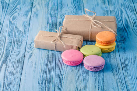 Set of various pastel colored macaroon and gift boxes with ribbonの写真素材