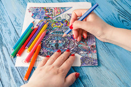 adult coloring books colored pencils anti-stress tendency. Hobbies woman's hands painting stress relief painterの写真素材