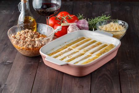 Woman make cannelloni with cheess. mediterranean cuisine cookindの写真素材