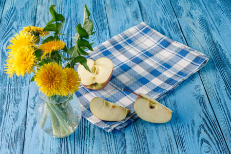 Spring breakfast on blue wooden table with dendelion flowersの写真素材