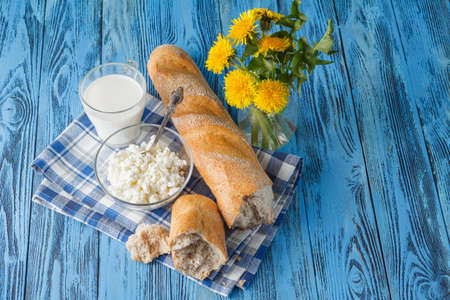 organic healthy food, cottage cheese and bread. Dandelion flowers on tableの写真素材