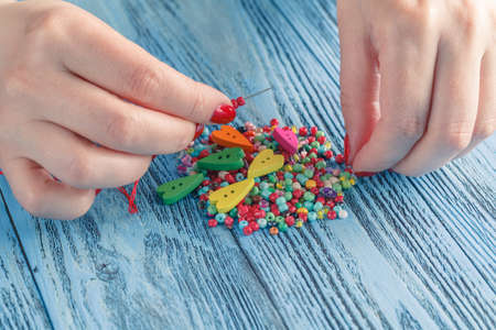 Woman making bears on rustic wooden tableの写真素材
