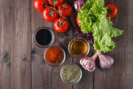 fresh vegetables and olive oil over wooden backgroundの写真素材