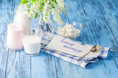 Delicious, nutritious and fresh plain yogurt and milk bottle with good morning messageの写真素材