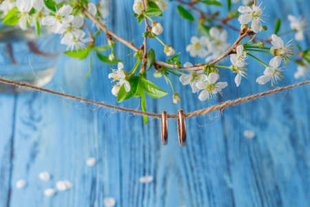 Wedding ring with spring cherry flowers backgroundの写真素材