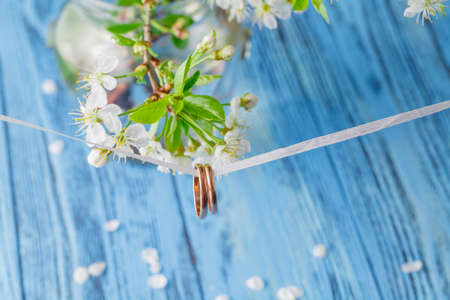 Cherry blossom on blue background. selective focus with wedding ringsの写真素材