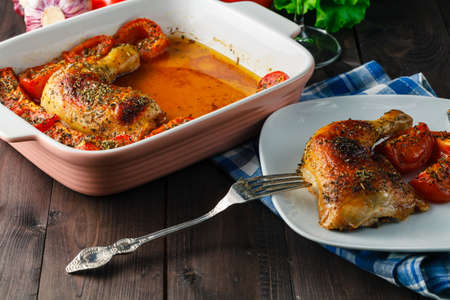 Baked chicken wings with vegetables on plateの写真素材