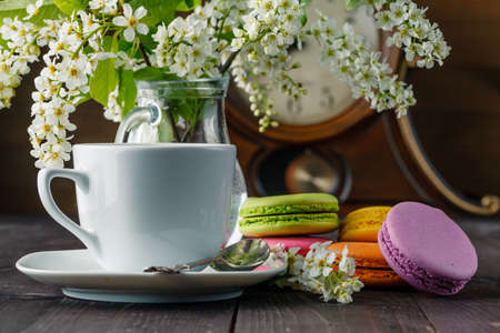 Spring breakfast with flowers and macaroonsの写真素材