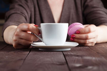 Breakfast concept. Coffee and macaron cookies on table in the morning