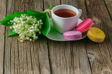 Tea mug with bouquet of flowers lily of the valleyの写真素材
