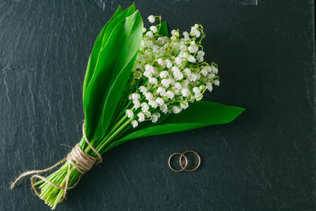 Bouquet of lilies of the valley on a dark background
