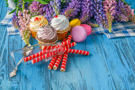 Summer morning breakfast in garden with lupine  flowers on tableの写真素材
